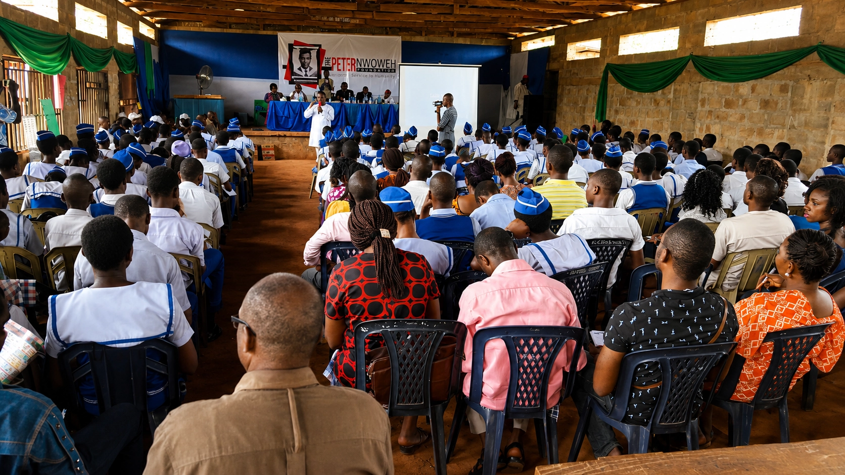 Frank Nweke II addressing students at Ozalla High School